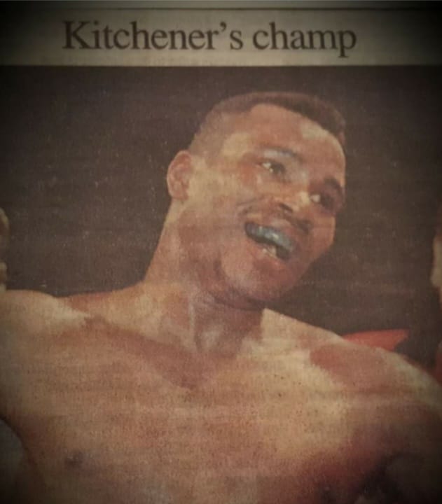Newspaper clipping headline reading 'Kitchener's champ' over a photo of Fitz Vanderpool in the ring
