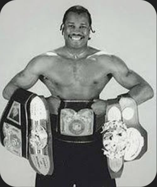 Vintage portrait of a young Fitz 'The Whip' Vanderpool wearing three professional world boxing championship belts